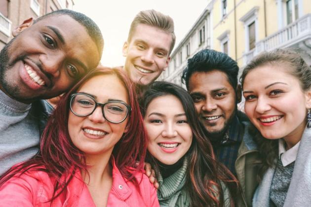 six young adults pose for a selfie 