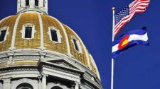 Colorado State Capitol's gold dome with USA flag and Colorado flag
